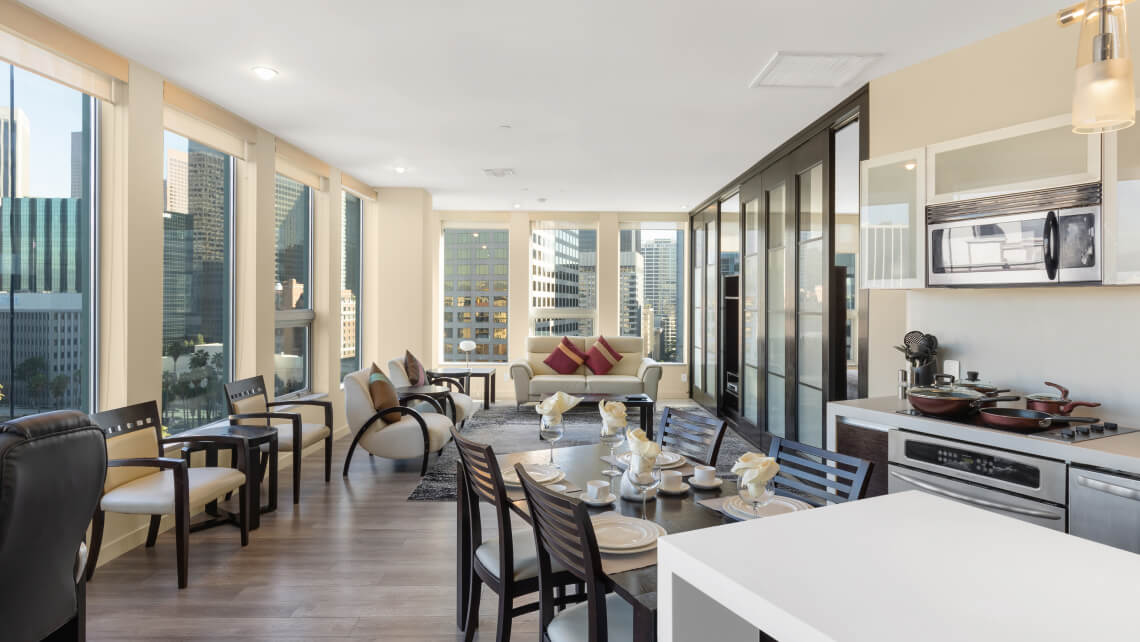 Lounge room with dining table and window view towards a city