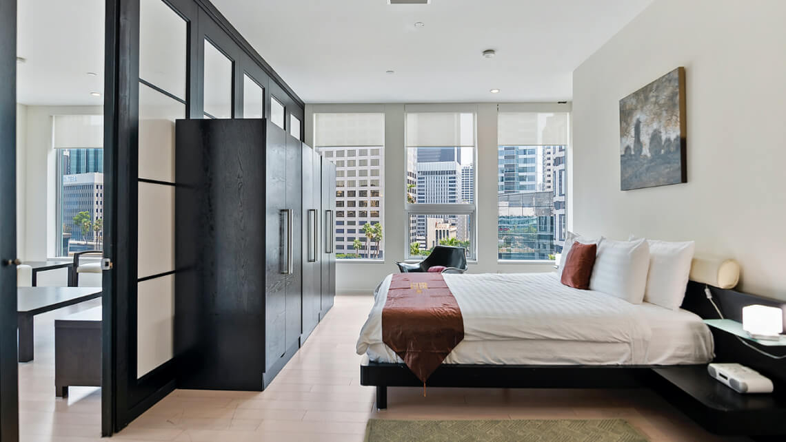bed room with window view towards a city