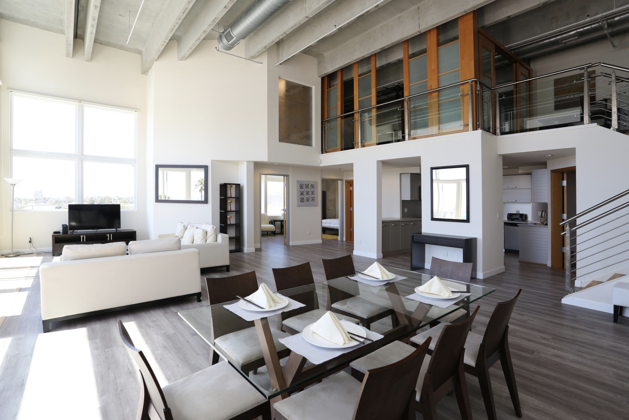 lounge and dining area, featuring various rooms in the 1st floor, and a view of a balcony in the second floor, featuring rooms.